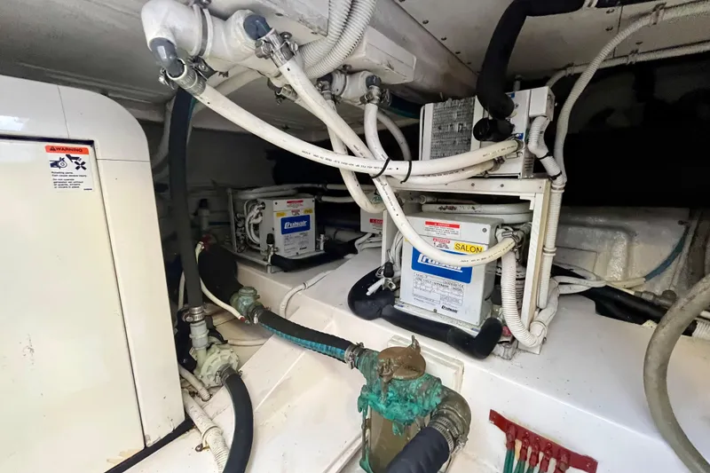 Slide: The Image of Engine compartment of a 2006 Bertram 390 Convertible with visible hoses and components. - 53