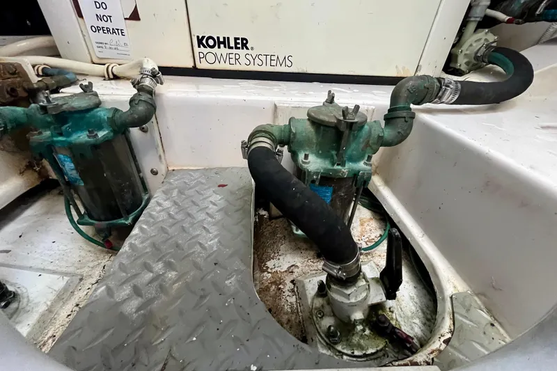 Slide: The Image of Engine room of 2006 Bertram 390 Convertible with cooling systems and piping. - 54