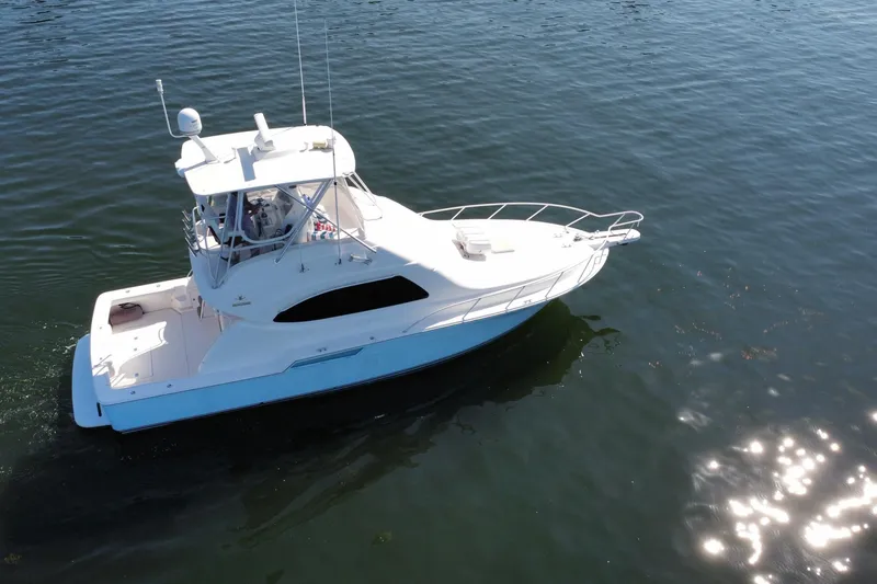 Slide: The Image of 2006 Bertram 390 Convertible cruising on open water, leaving a wake behind. - 58