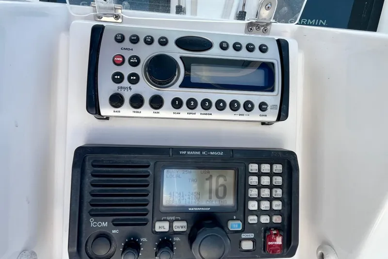 Slide: The Image of Control panel of a 2006 Bertram 390 Convertible boat with thruster and communication equipment. - 63