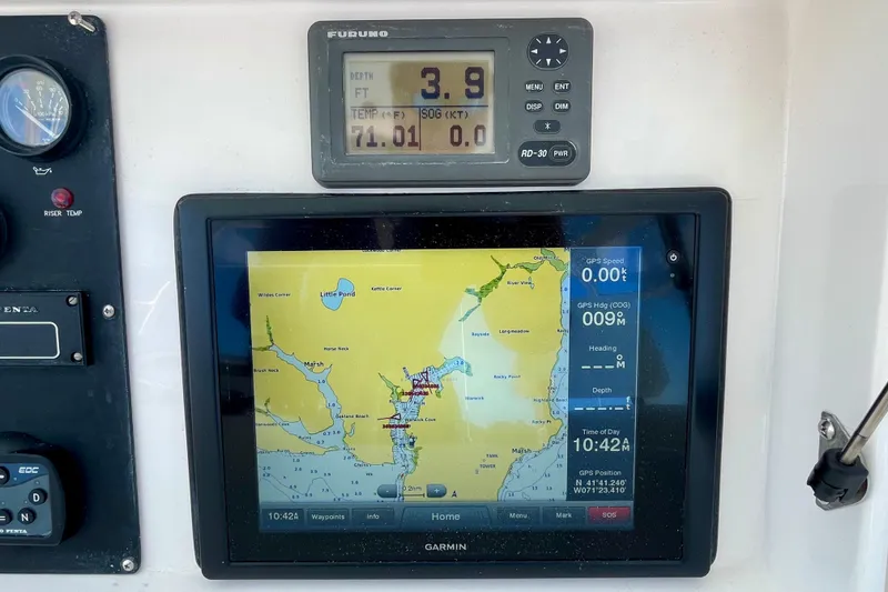 Slide: The Image of ICOM marine radios on a 2006 Bertram 390 Convertible yacht dashboard. - 64