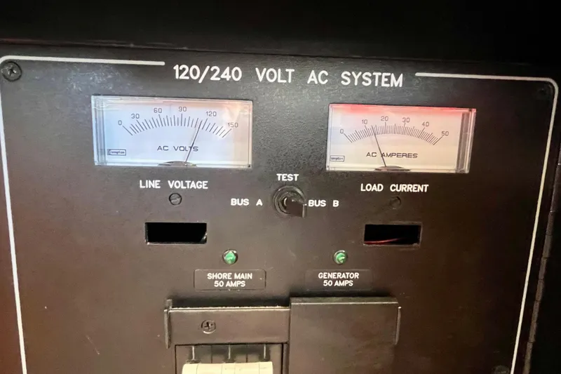 Slide: The Image of Electrical panel of a 2006 Bertram 390 Convertible boat, showcasing AC and DC systems. - 70