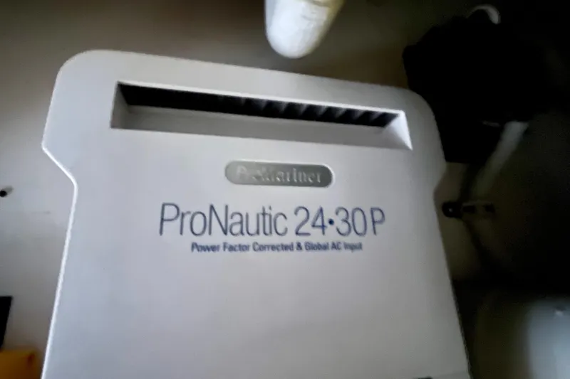 Slide: The Image of Bertram 390 Convertible 2006 with Garmin radar in a marina under clear blue sky. - 76