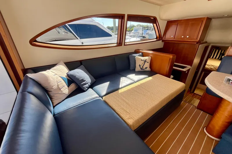 Slide: The Image of Interior of 2006 Bertram 390 Convertible yacht with cozy seating and nautical decor. - 84