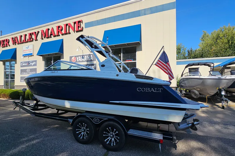 The Image of 2022 Cobalt R4 boat on trailer outside River Valley Marine dealership. - 1