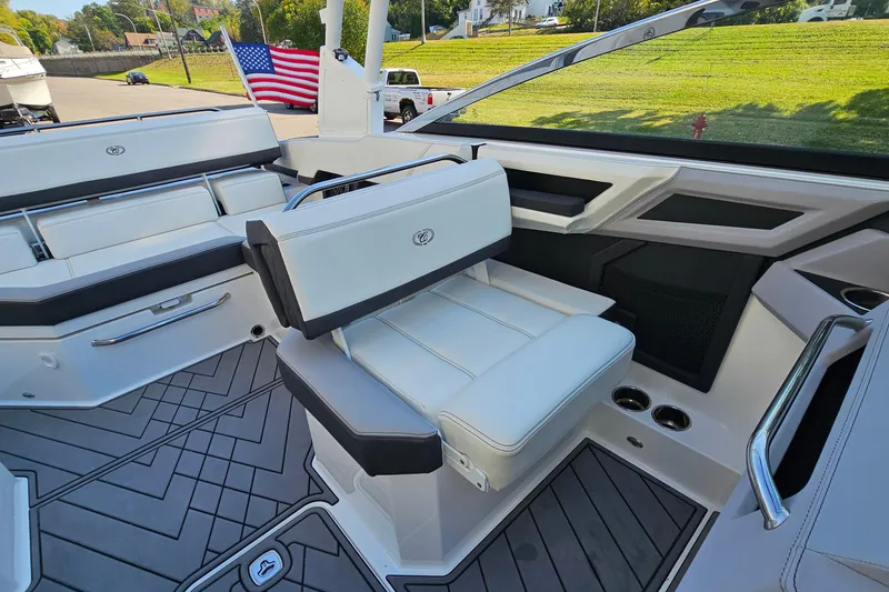 Slide: The Image of 2022 Cobalt R4 boat interior with white seating and American flag in the background. - 13