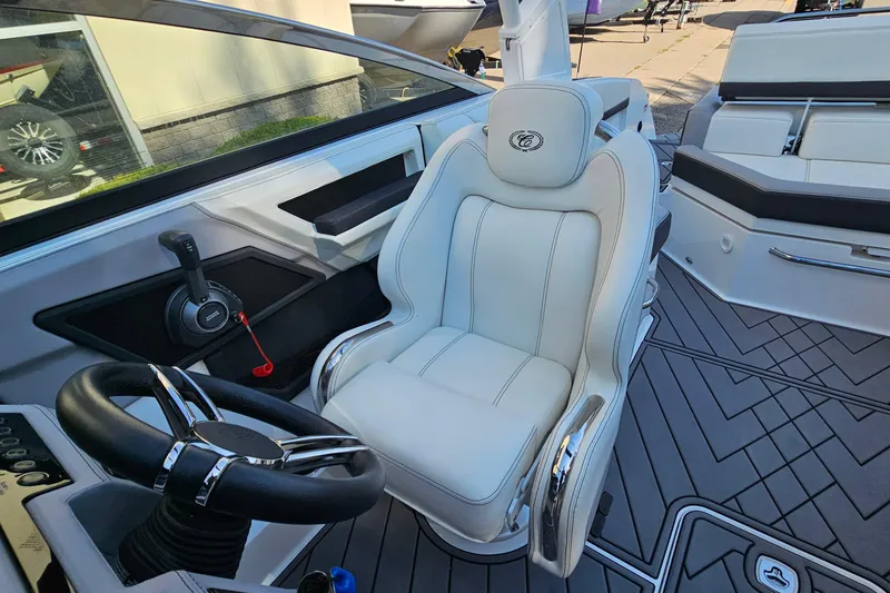 Slide: The Image of 2022 Cobalt R4 boat interior with white captain's seat and steering wheel. - 14