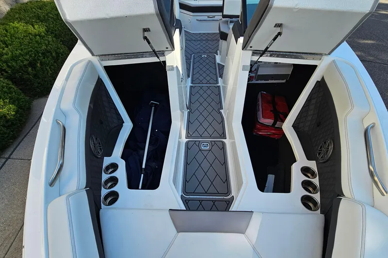 Slide: The Image of 2022 Cobalt R4 boat interior with open storage compartments and seating area. - 22