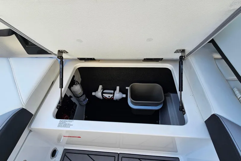 Slide: The Image of Open storage compartment in 2022 Cobalt R4 boat, featuring organized interior space. - 24