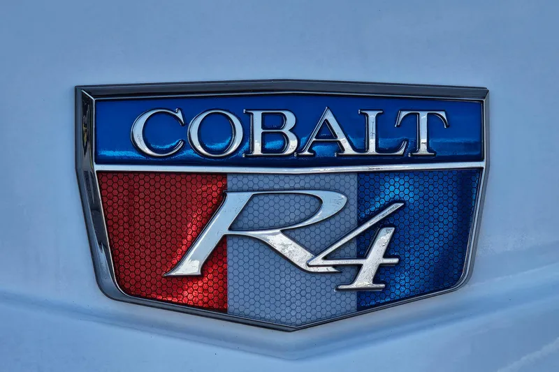 Slide: The Image of 2022 Cobalt R4 emblem with red, white, and blue design on a vehicle. - 29