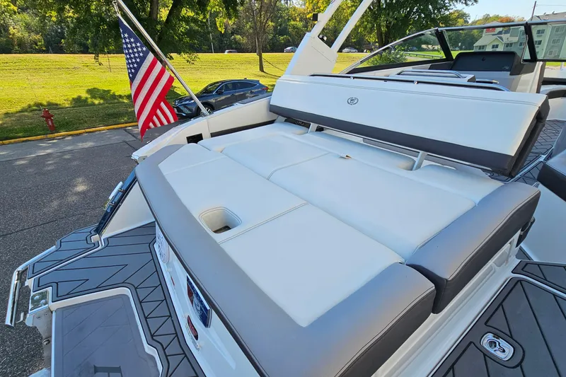 Slide: The Image of 2022 Cobalt R4 boat with American flag, featuring sleek white seating and modern design. - 7