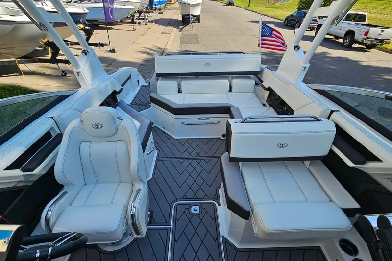 Slide: The Image of 2022 Cobalt R4 boat interior with luxurious white seating and American flag. - 9