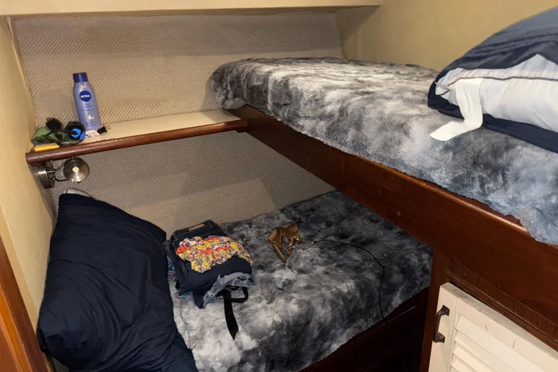Slide: The Image of Cozy 1988 Ocean Convertible cabin with bunk beds and personal items. - 12