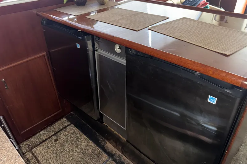 Slide: The Image of 1988 Ocean Convertible yacht kitchen with compact appliances and wooden countertop. - 16