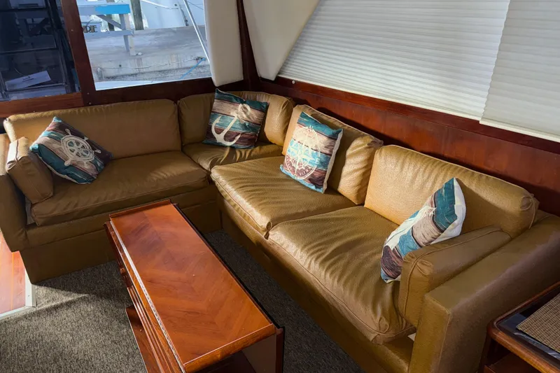 Slide: The Image of Luxurious 1988 Ocean Convertible yacht interior with cozy seating and nautical-themed pillows. - 17