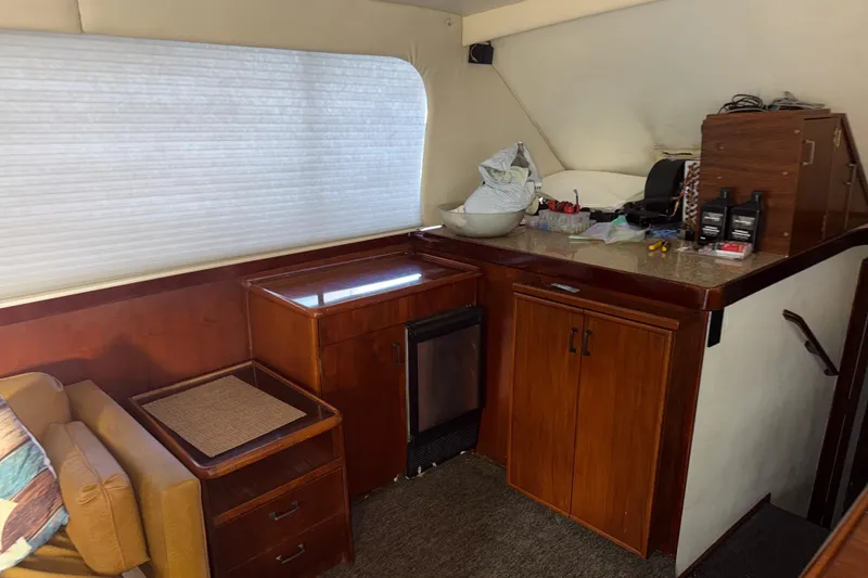 Slide: The Image of 1988 Ocean Convertible yacht interior with wooden cabinets and seating area. - 9