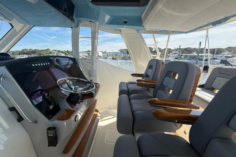 Slide: The Image of 2024 Boston Whaler 420 Outrage helm with luxurious seating and advanced navigation controls. - 30