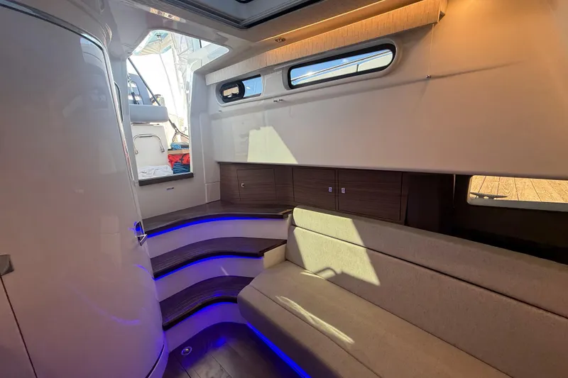 Slide: The Image of Interior of 2024 Boston Whaler 420 Outrage, featuring modern seating and ambient lighting. - 41