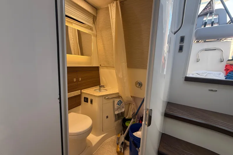 Slide: The Image of 2024 Boston Whaler 420 Outrage bathroom interior with modern fixtures and wooden accents. - 44
