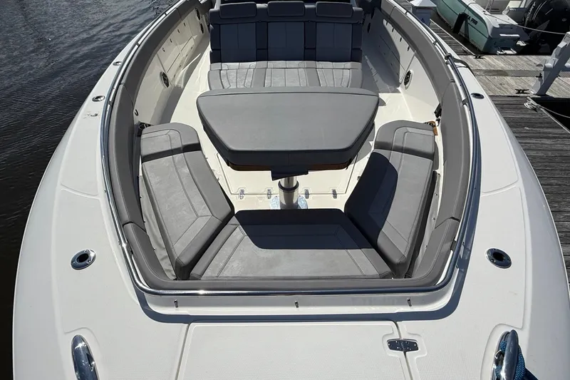 Slide: The Image of 2024 Boston Whaler 420 Outrage boat with spacious seating and table on deck. - 49