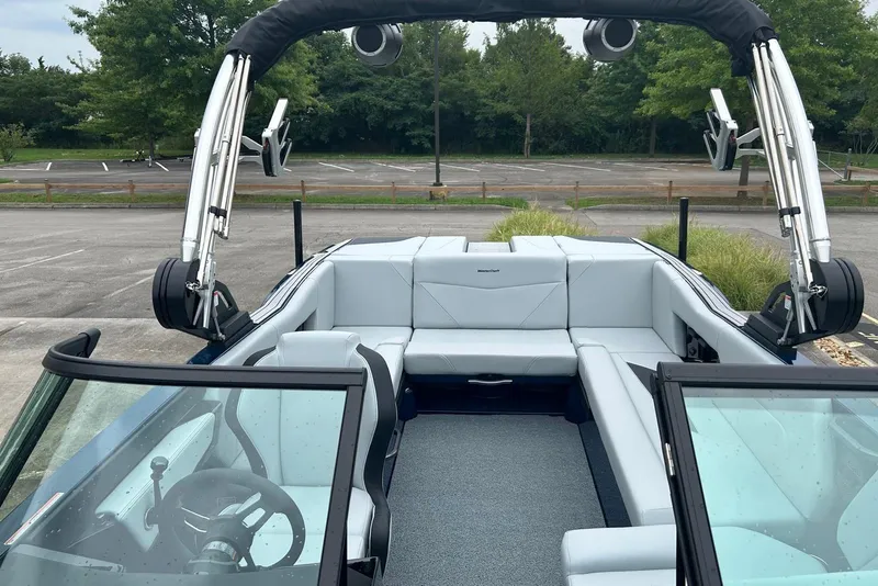 Slide: The Image of 2025 MasterCraft NXT23 boat interior with sleek seating and modern design. - 10