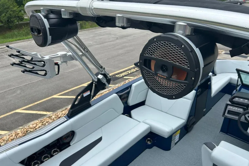 Slide: The Image of 2025 MasterCraft NXT23 boat interior with speakers and seating, showcasing modern design. - 12