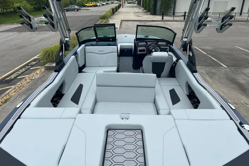 Slide: The Image of 2025 MasterCraft NXT23 boat interior with sleek seating and modern design. - 13