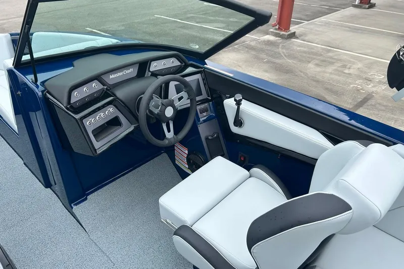 Slide: The Image of 2025 MasterCraft NXT23 boat interior with modern dashboard and steering wheel. - 8