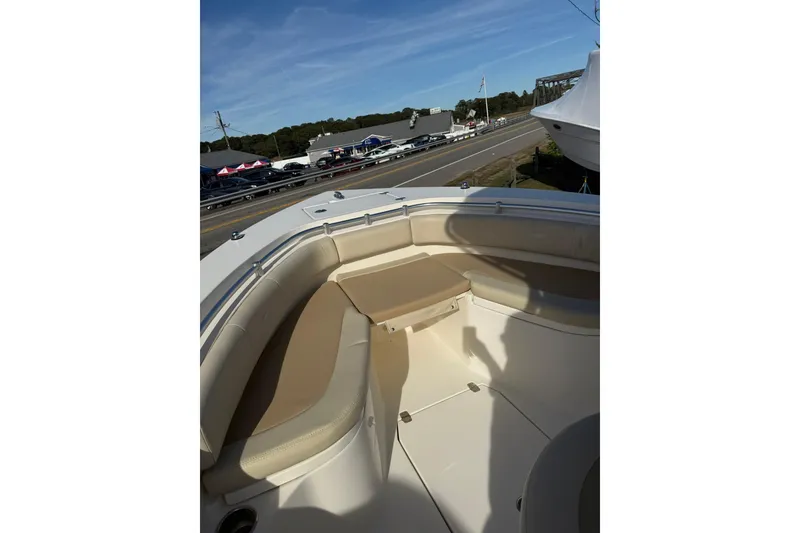Slide: The Image of 2013 Cobia 237 Center Console boat interior with beige seating and open deck. - 12