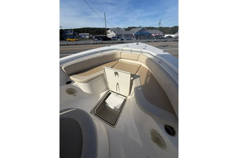 Slide: The Image of 2013 Cobia 237 Center Console boat interior with open storage compartment and seating. - 13