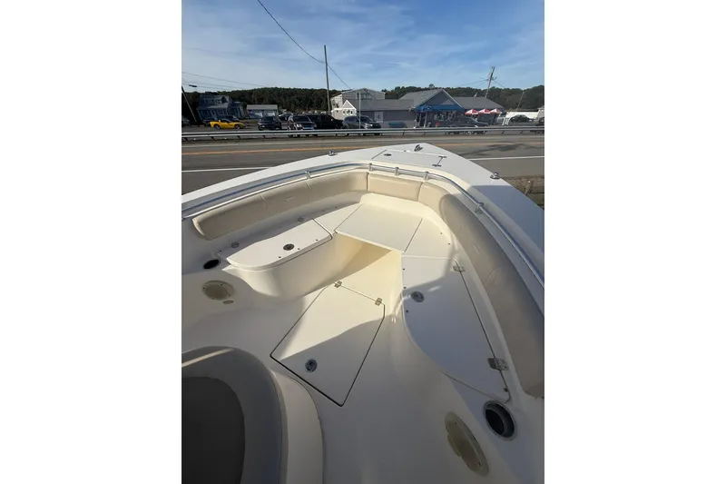 Slide: The Image of 2013 Cobia 237 Center Console boat interior with seating and storage compartments. - 14