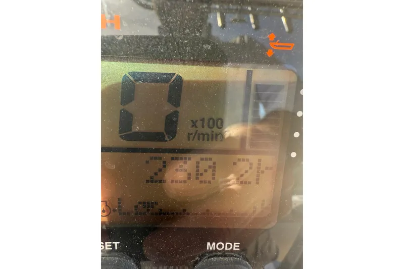 Slide: The Image of Close-up of a 2013 Cobia 237 Center Console digital display showing RPM and indicators. - 19