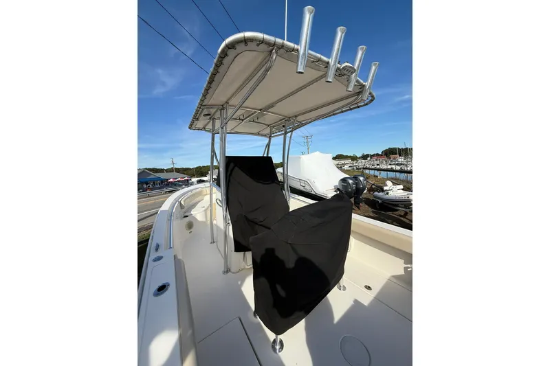 Slide: The Image of 2013 Cobia 237 Center Console boat with T-top and covered seating. - 20