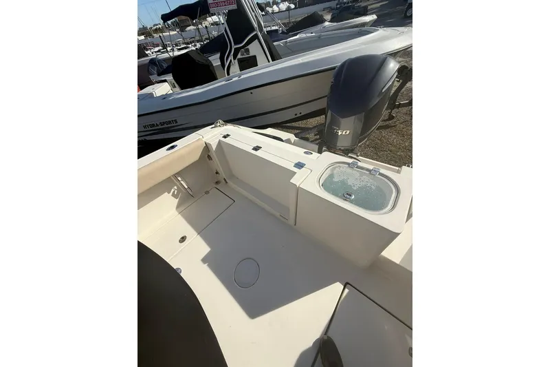 Slide: The Image of 2013 Cobia 237 Center Console boat with livewell and outboard motor. - 5