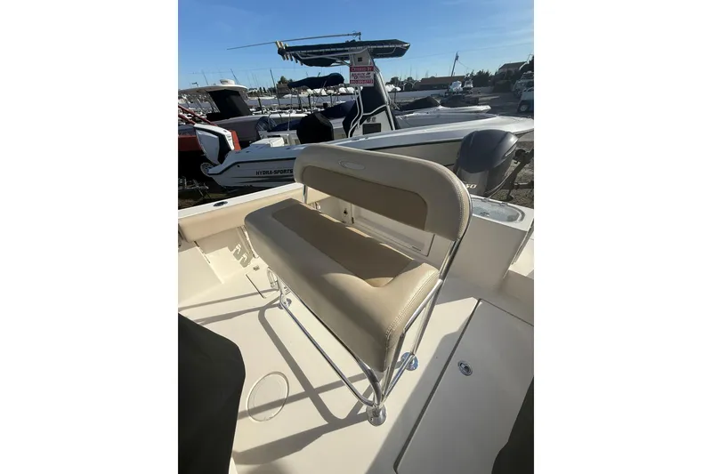 Slide: The Image of 2013 Cobia 237 Center Console boat with beige seating and Yamaha outboard motor. - 8