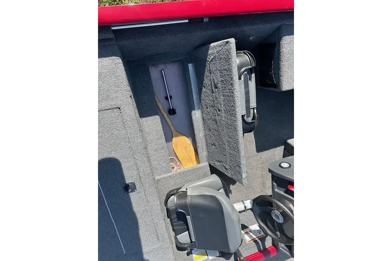 Slide: The Image of Interior of 2025 Tracker Pro 170 boat showing storage compartment and paddle. - 9