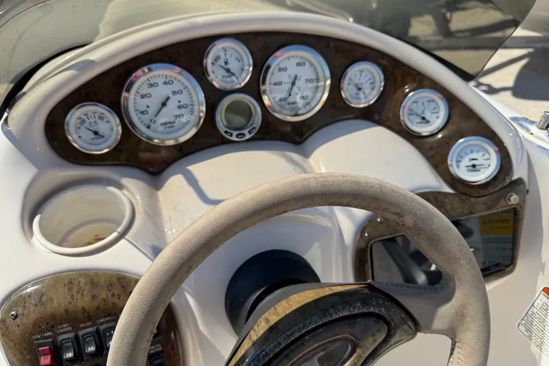 Slide: The Image of Dashboard of a 2008 Tahoe 195 boat with gauges and steering wheel. - 11