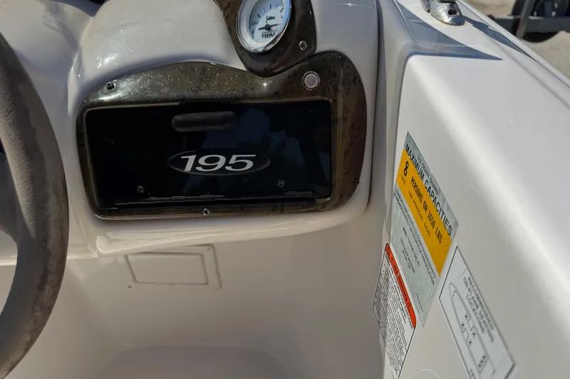 Slide: The Image of 2008 Tahoe 195 boat dashboard with capacity label and gauge. - 13