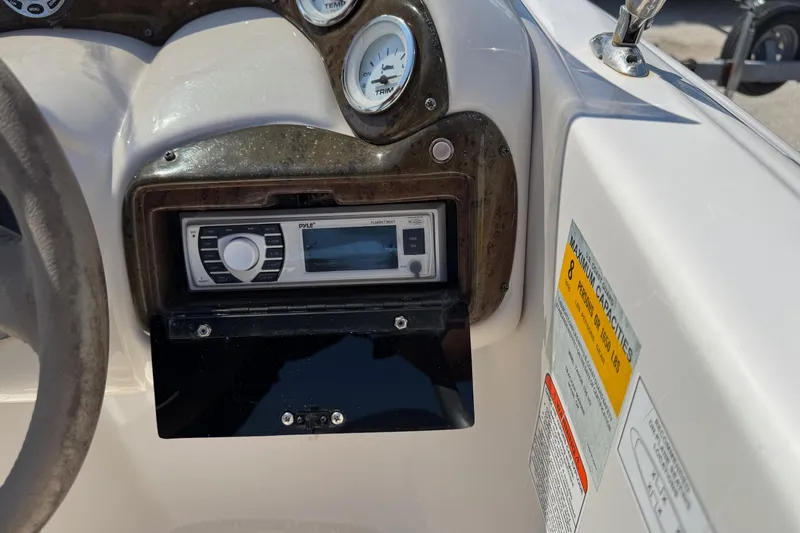 Slide: The Image of Dashboard of a 2008 Tahoe 195 boat featuring gauges and a Pyle stereo system. - 14