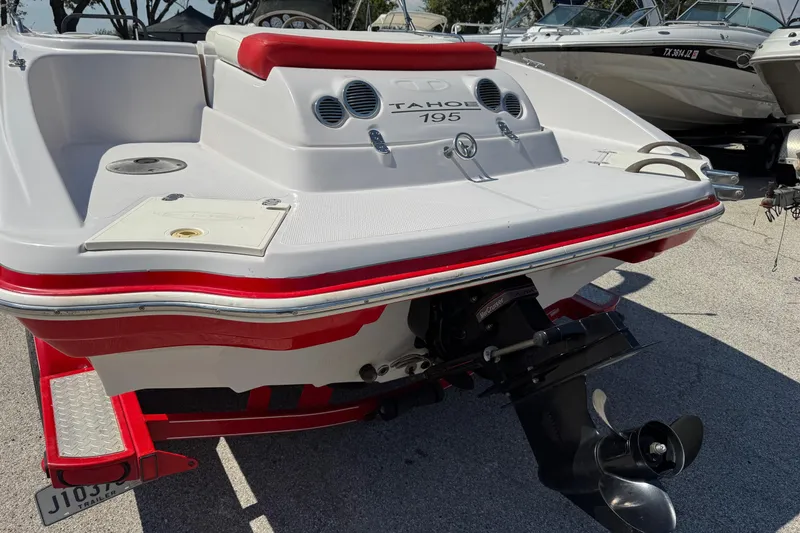 Slide: The Image of 2008 Tahoe 195 boat, red and white, rear view with outboard motor. - 4