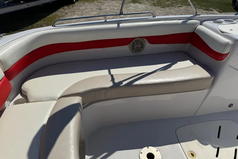 Slide: The Image of 2008 Tahoe 195 boat interior with red and white seating, cup holders, and speaker. - 8