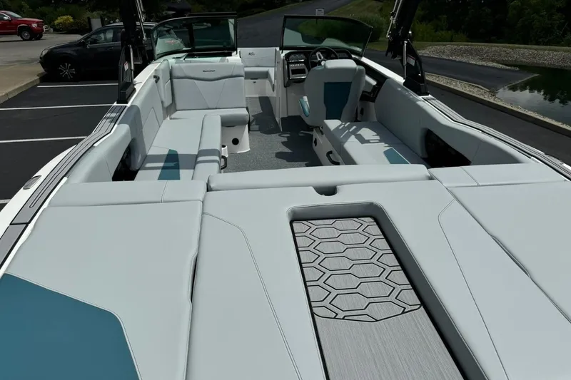 Slide: The Image of 2025 MasterCraft NXT24 boat interior with modern seating and sleek design. - 13