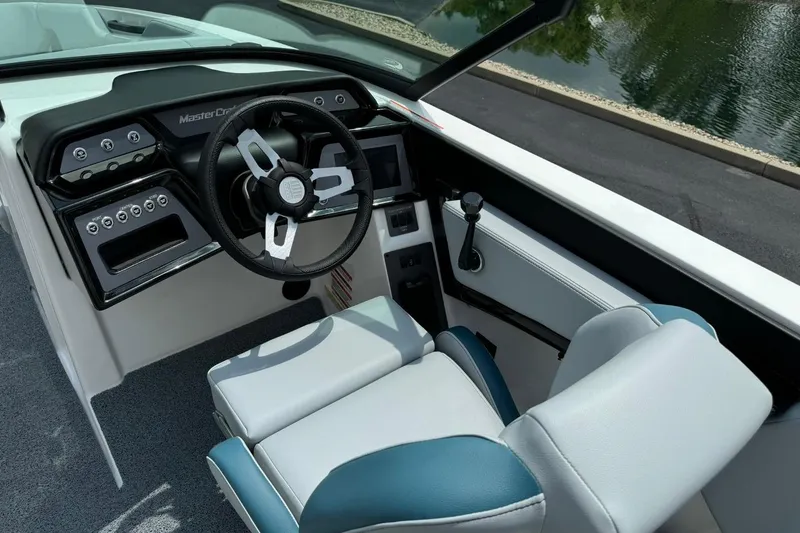 Slide: The Image of 2025 MasterCraft NXT24 boat interior with modern steering wheel and control panel. - 9
