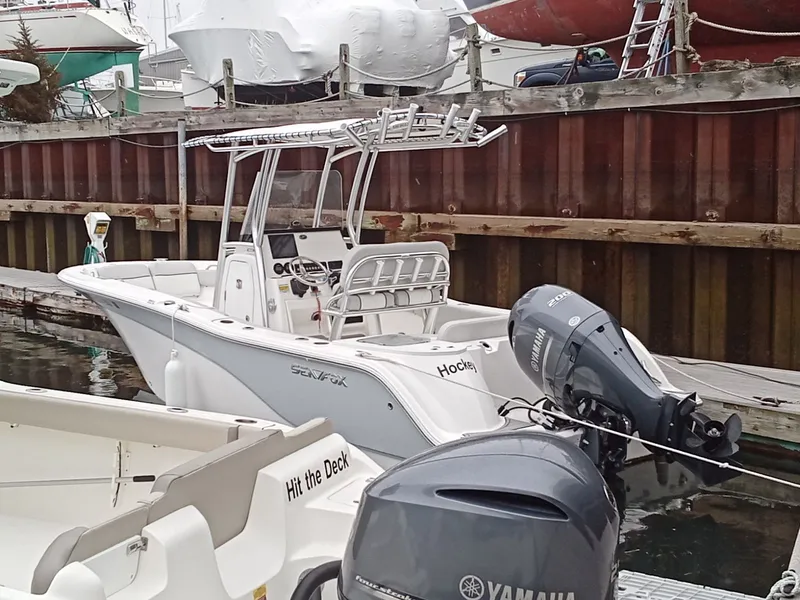 Slide: The Image of 2023 Sea Fox 228 Commander boat docked with Yamaha outboard motor. - 2