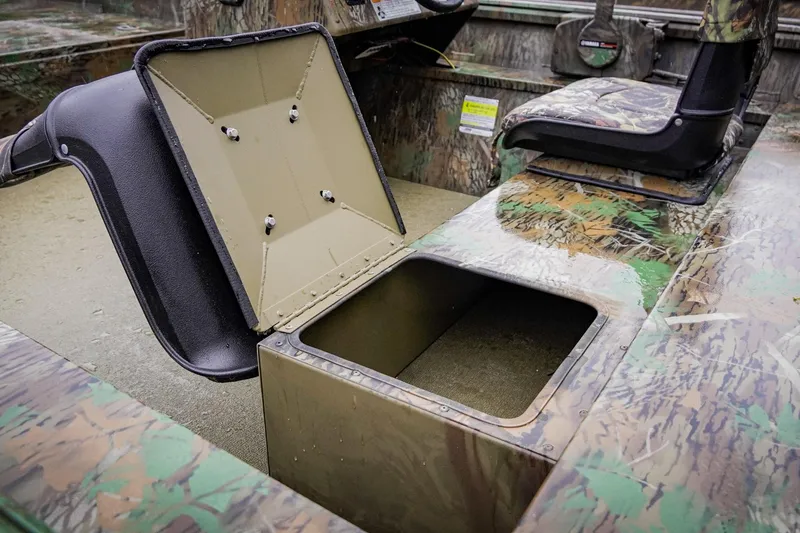 Slide: The Image of Open storage compartment in 2026 G3 17SC boat with camo design interior. - 16