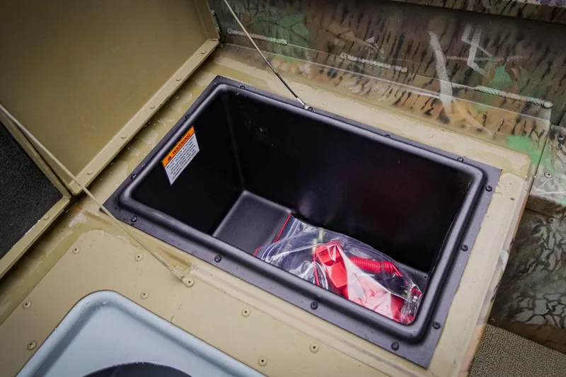 Slide: The Image of Storage compartment in 2026 G3 17SC boat, featuring a plastic bag with red accessories. - 20