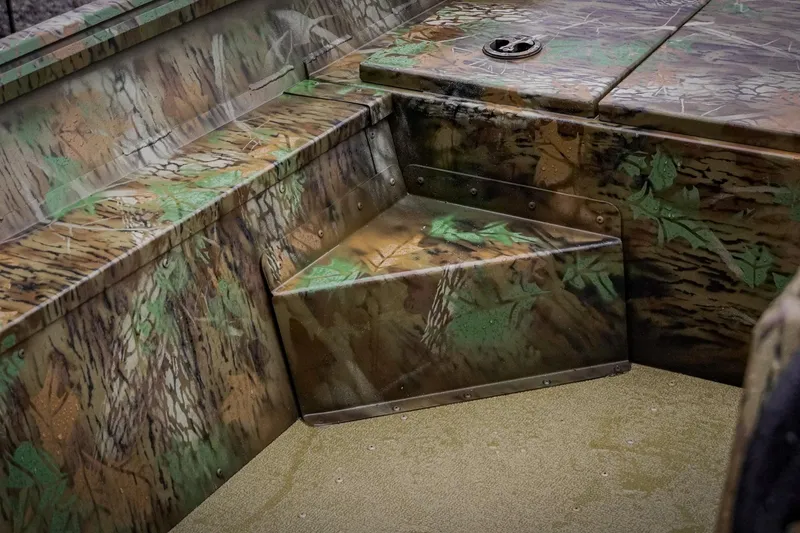Slide: The Image of Camouflage interior of 2026 G3 17SC boat with textured seating and storage. - 22