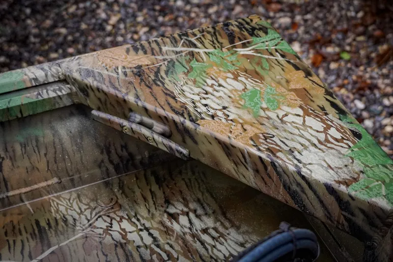 Slide: The Image of Camouflage-patterned G3 17SC boat detail, 2026 model, on gravel background. - 24