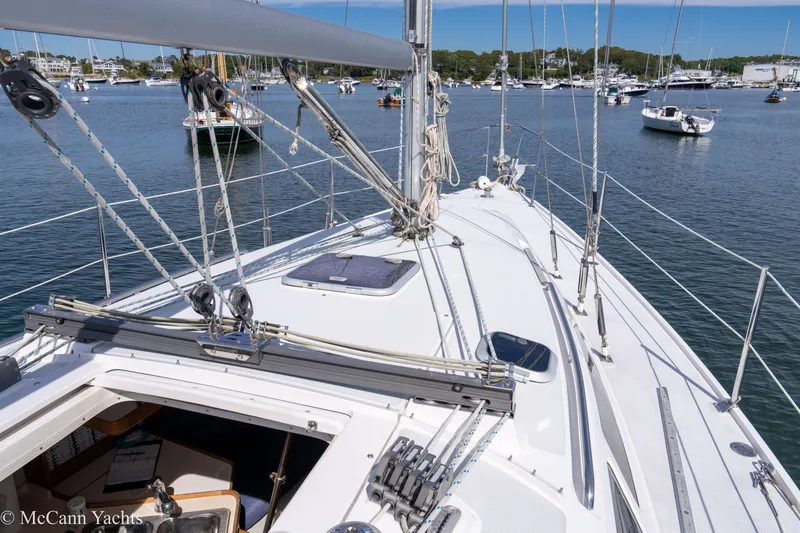 Slide: The Image of 2003 Catalina 320 sailboat deck view in a marina with other boats. - 11