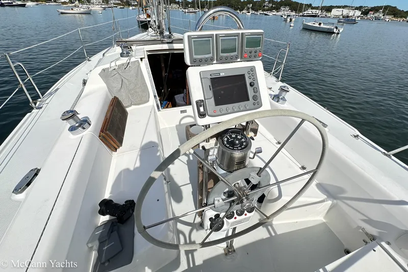 Slide: The Image of Cockpit of 2003 Catalina 320 sailboat with navigation equipment and steering wheel. - 12